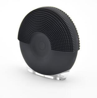 Using electric facial cleansing brush on skin