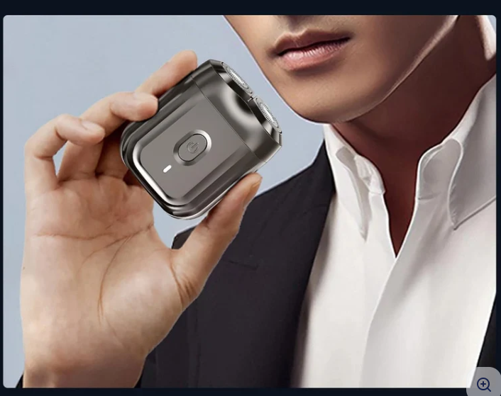 Man using a compact electric shaver